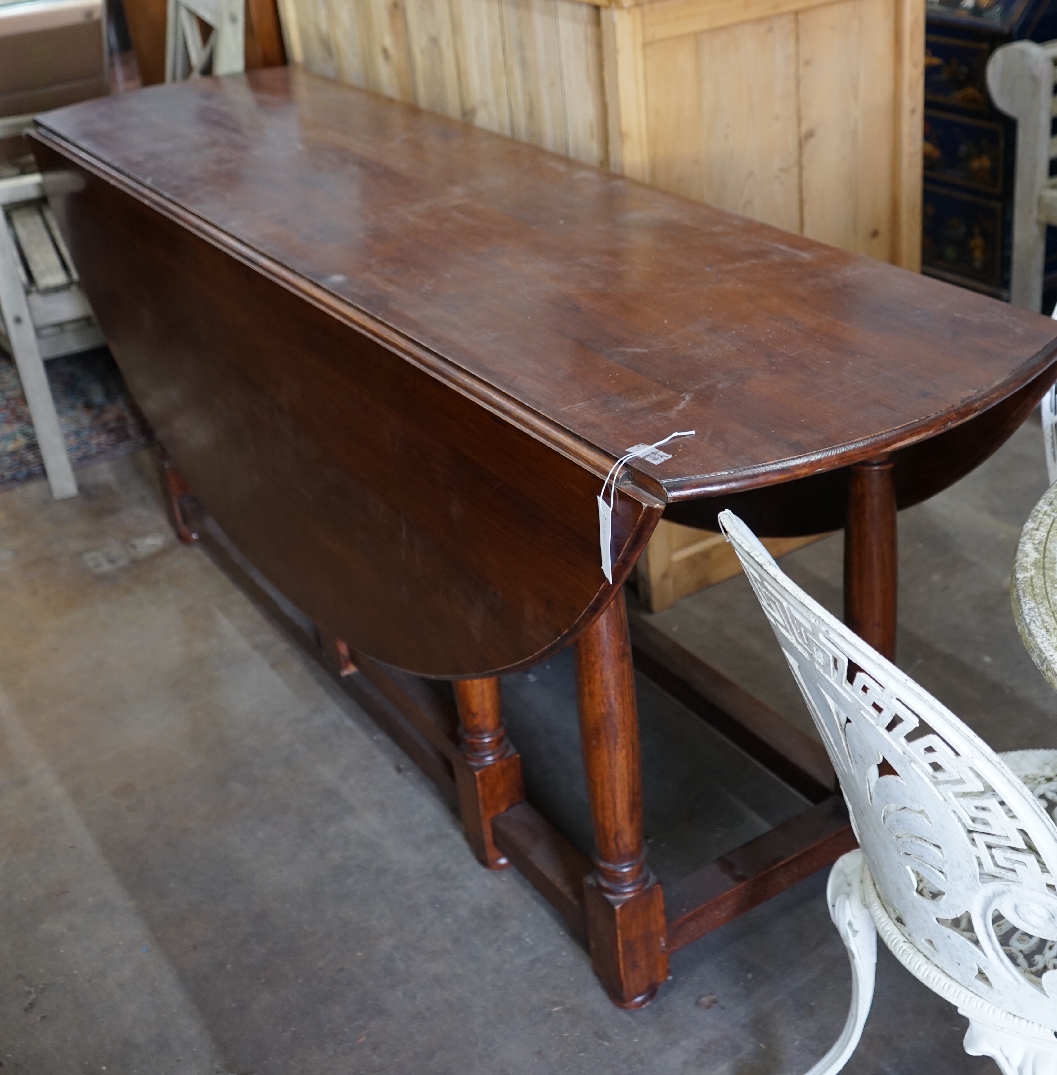 An 18th century style oak gateleg wake dining table, length 190cm extended 150cm height 79cm